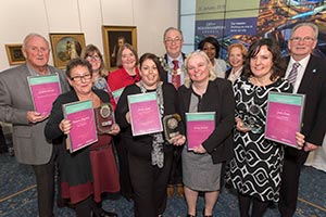 Group of people holding their Dementia Friendly Awards